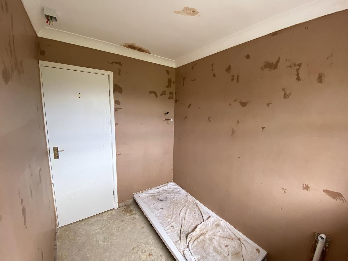 The same small room with its walls freshly skimmed