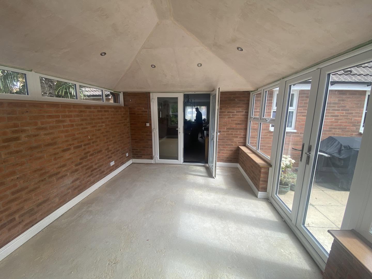 The finished garden room, brick wall and the doors back into the house