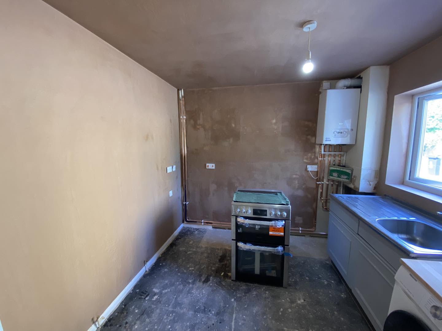 The same kitchen walls skimmed, with the cooker and boiler