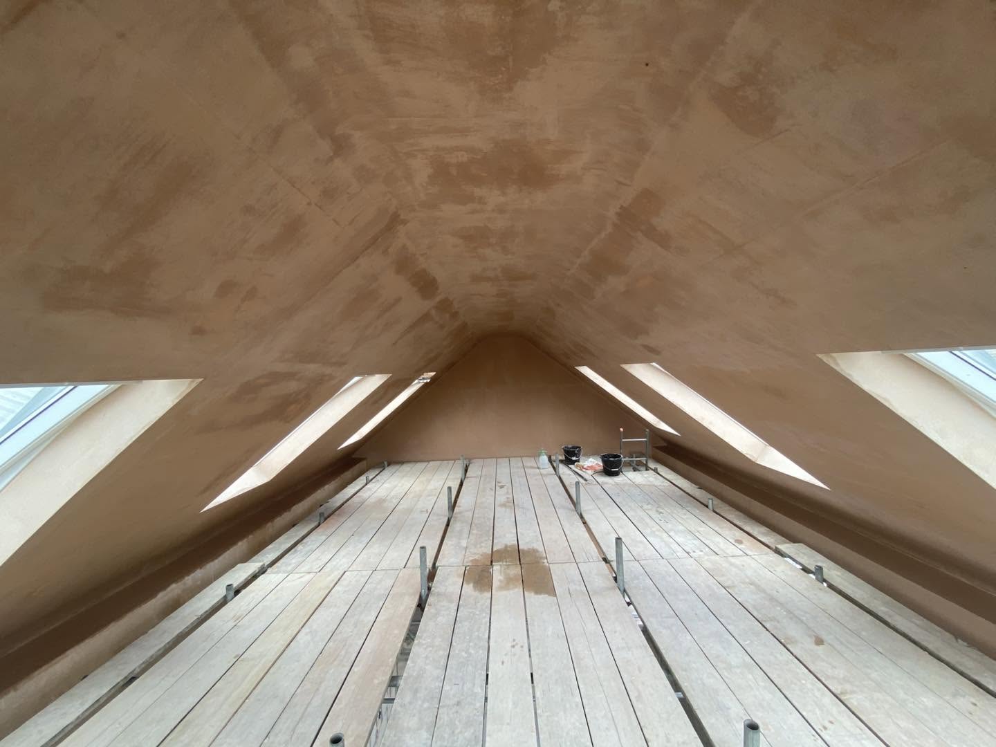 The finished loft conversion: vaulted ceiling skimmed, roof windows, boarded floor