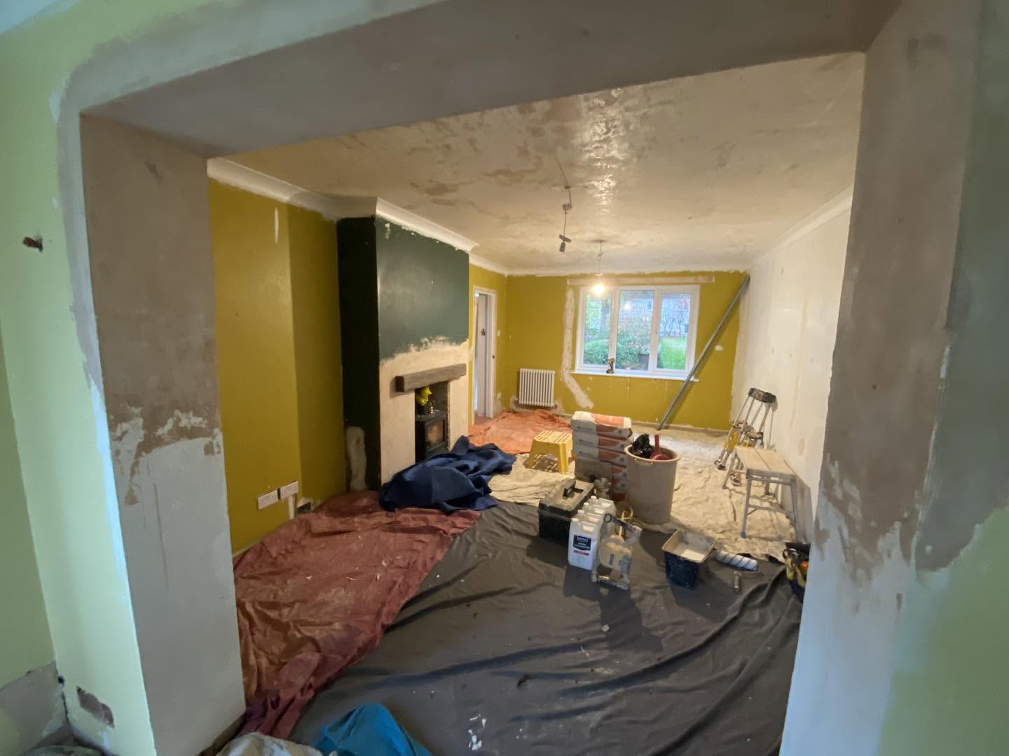Looking through an opening into the same room, dust sheets down