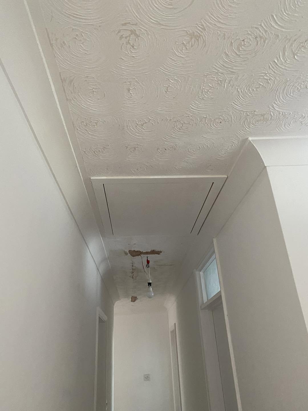 A hallway ceiling covered in swirl Artex
