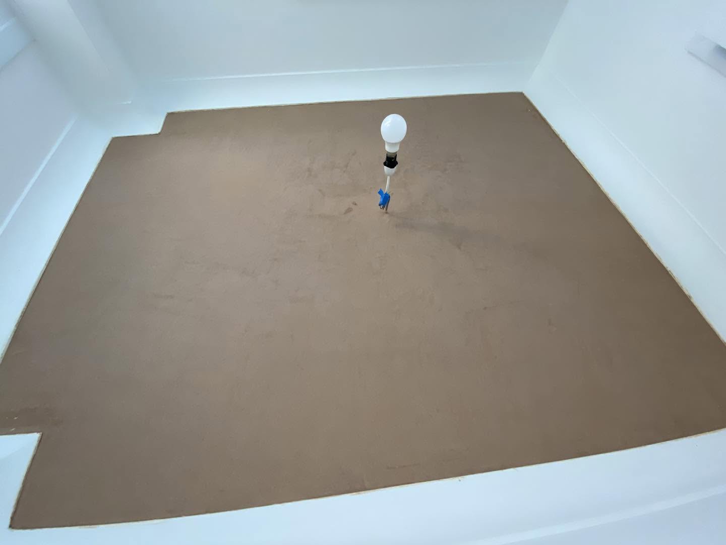 A room ceiling freshly skimmed in pink plaster above white walls
