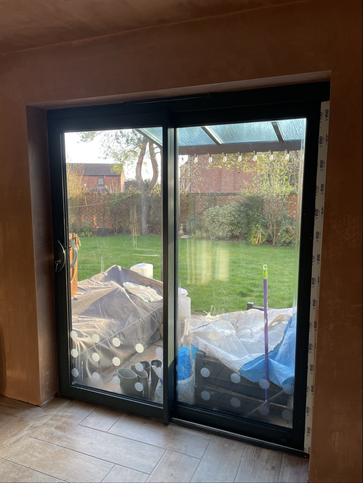 Fresh plaster around new sliding patio doors, the garden beyond
