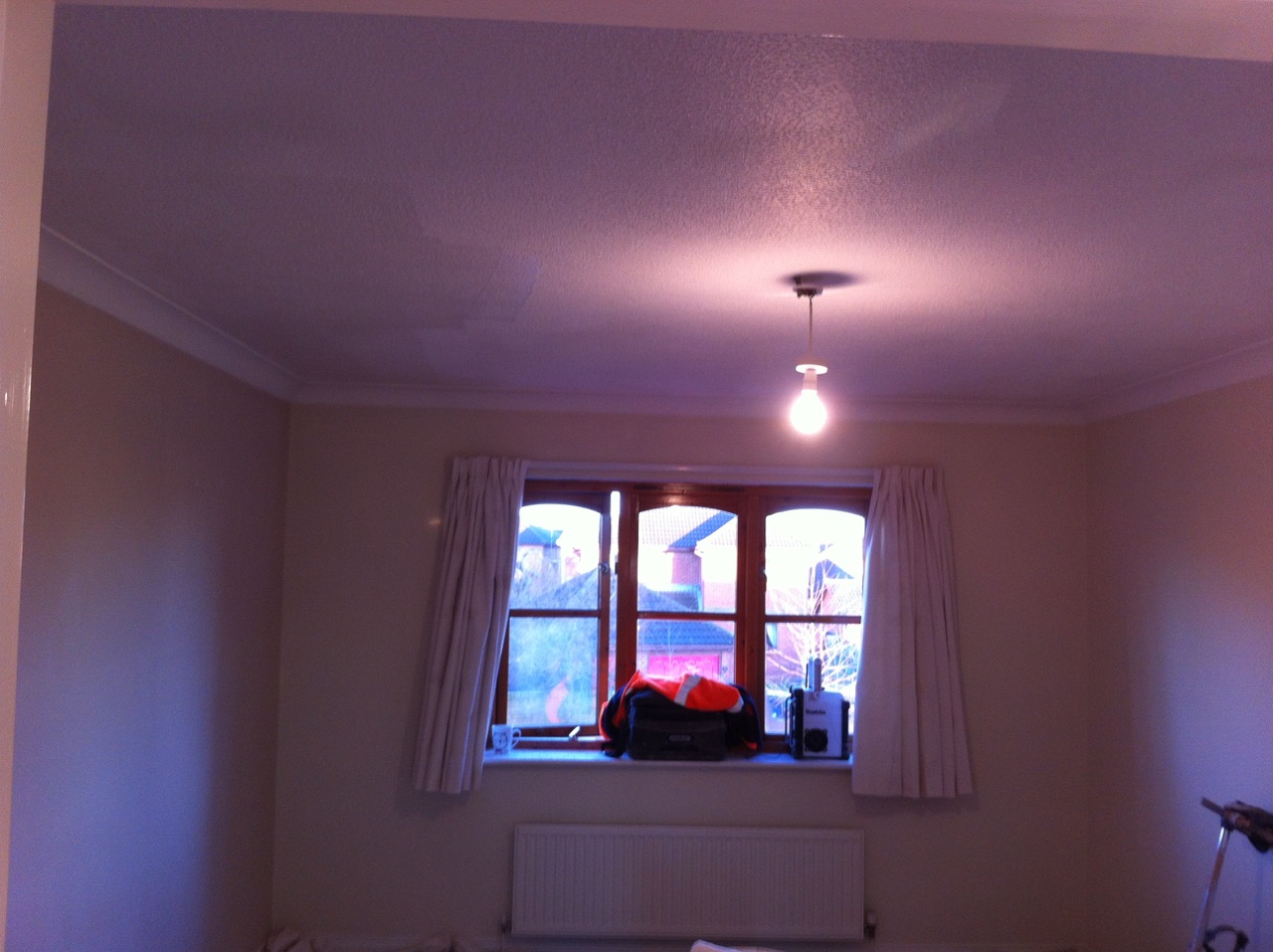 A finished, painted bedroom with coving