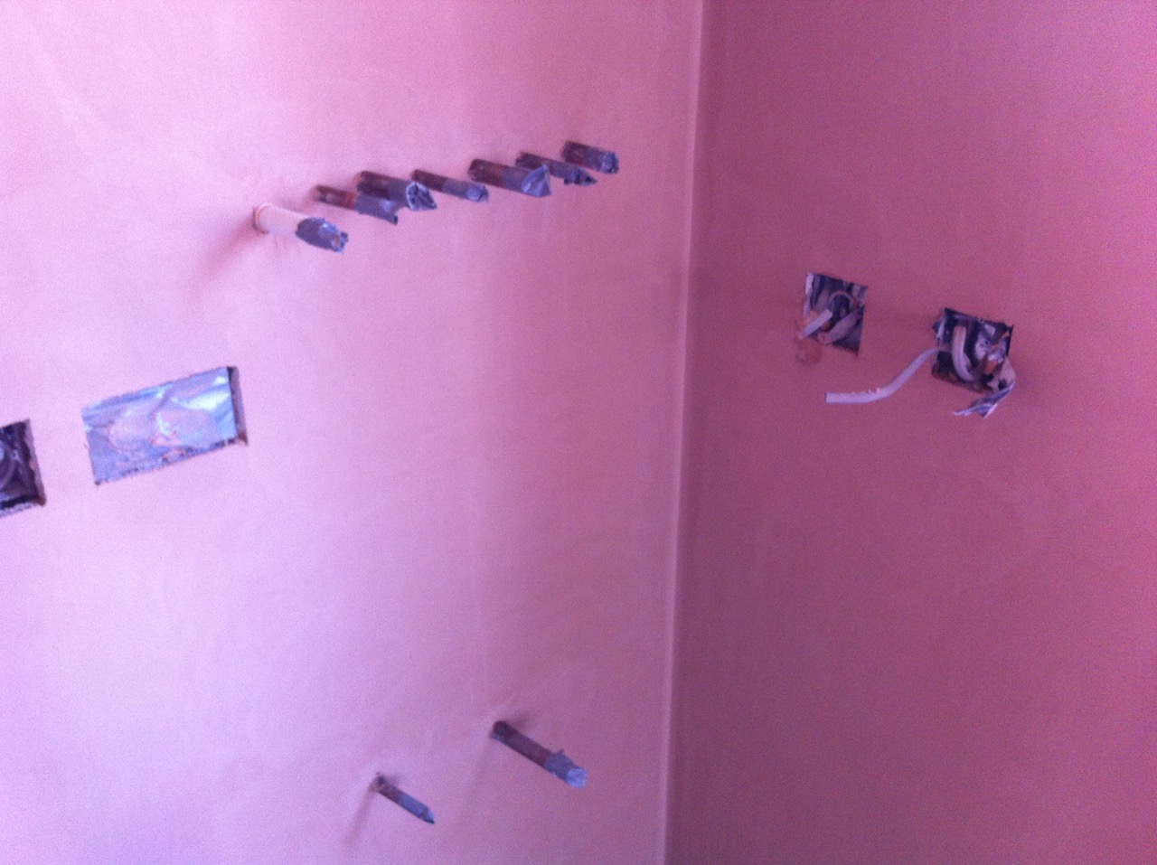 A skimmed wall with fixings and sockets