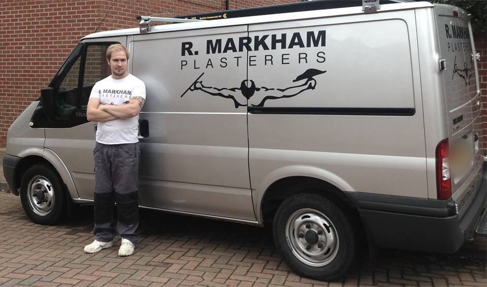 A silver van lettered R. Markham Plasterers with the plasterer mark, and a man in a Markham Plasterers t-shirt beside it